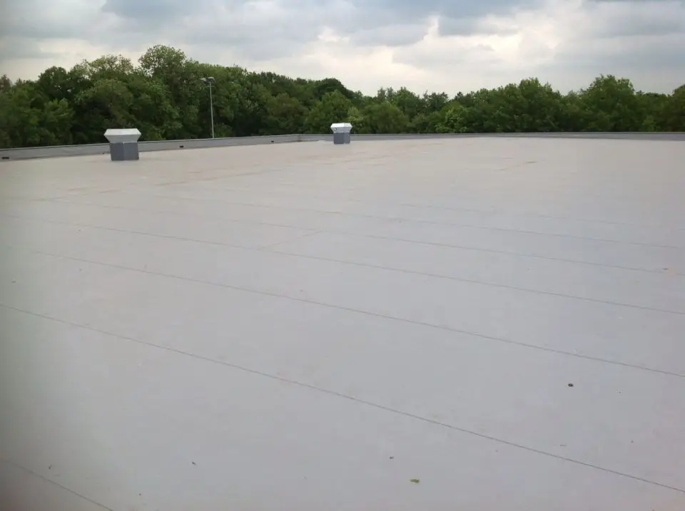 Groot plat dak met nieuwe grijze dakbedekking